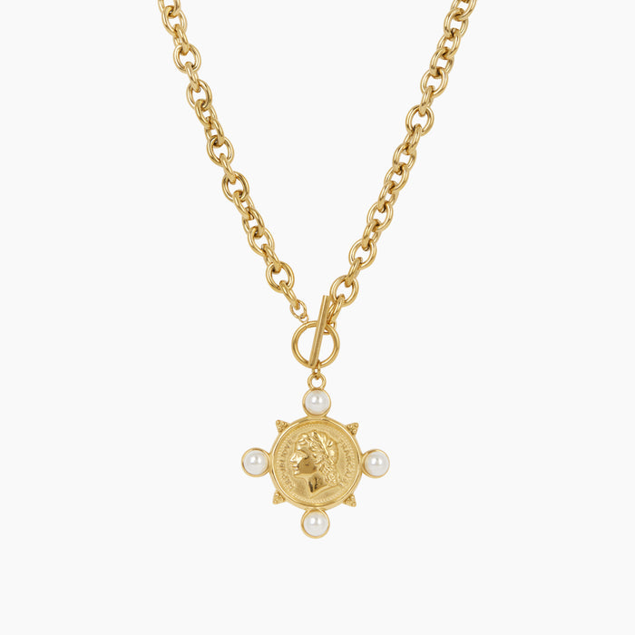 A gold chain necklace featuring a circular gold pendant with a profile portrait, surrounded by four small white pearl beads at the points, shown on a plain light gray background.