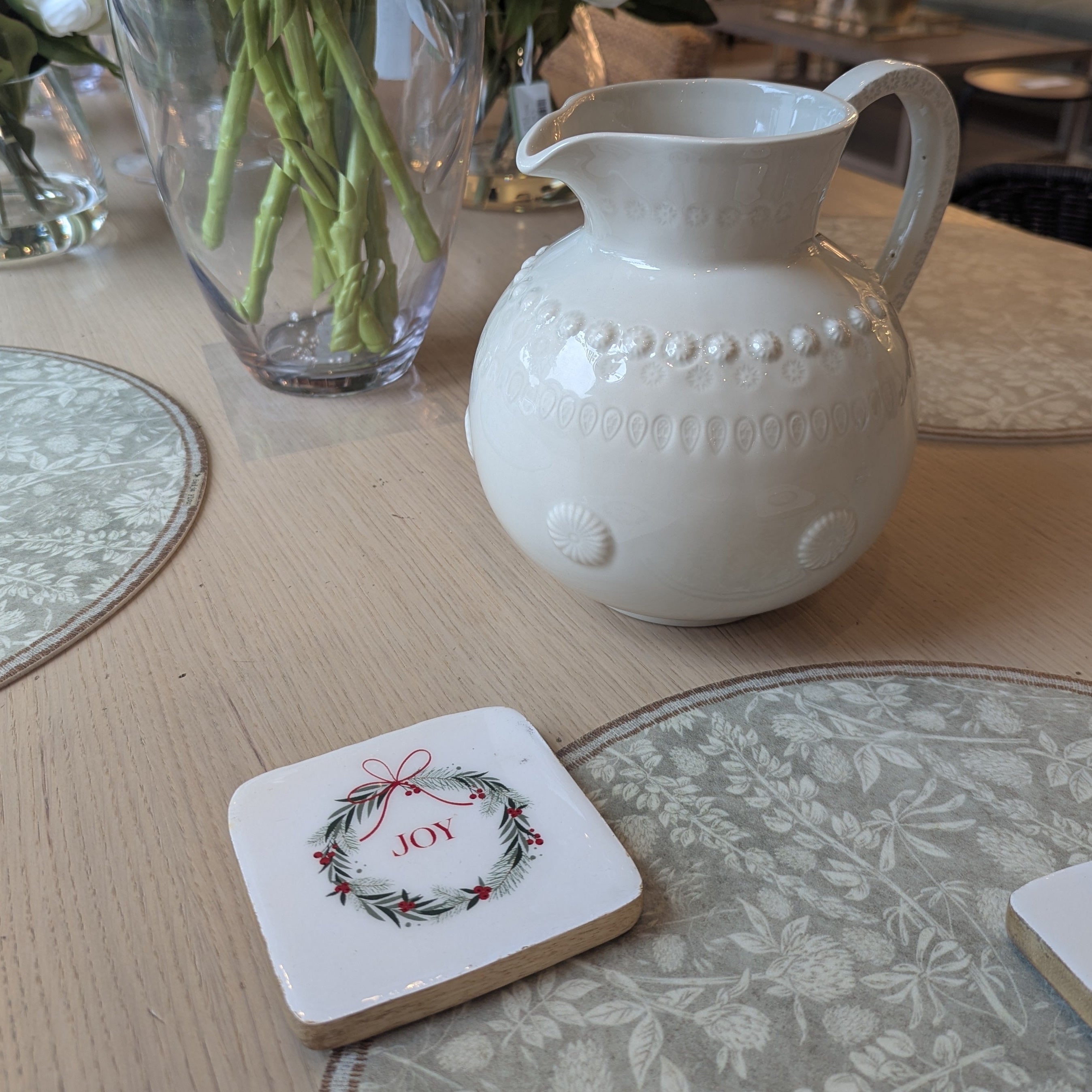 Set of 4 christmas coasters with wreath design and christmas sayings.