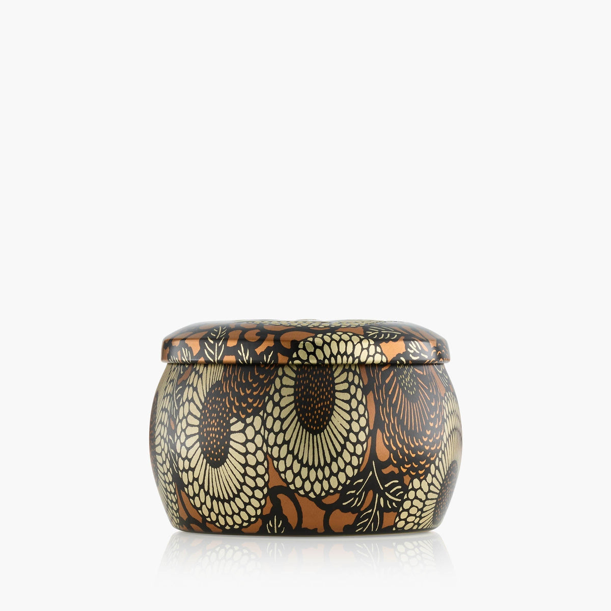 VOLUSPA Baltic Amber Mini Tin Candle, lit and burning