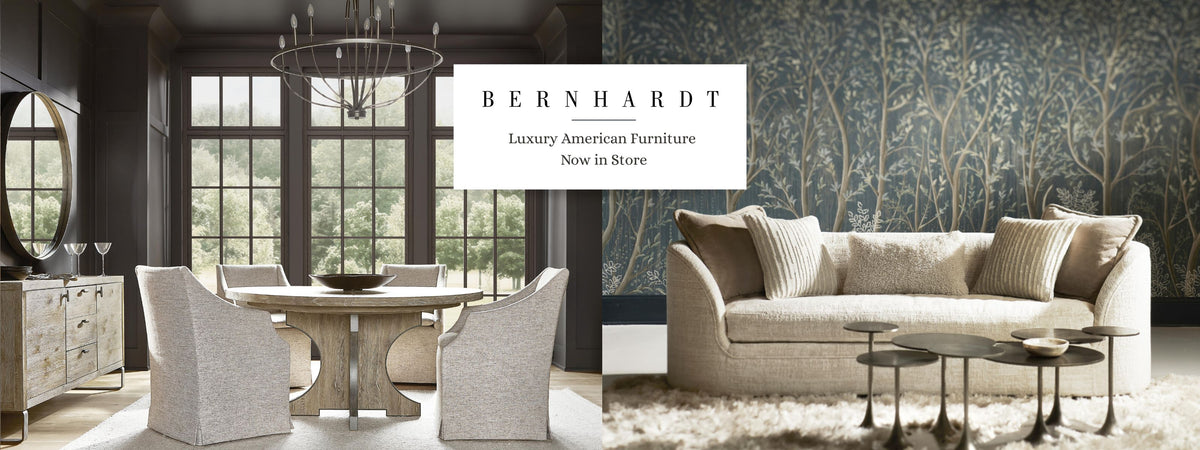 A split-screen promotional banner for Bernhardt, showing a dining room on the left with a round wooden table and upholstered chairs, and a living room on the right with a beige sofa, patterned wallpaper, and coffee tables. A white text box in the center reads 'BERNHARDT Luxury American Furniture Now in Store'.