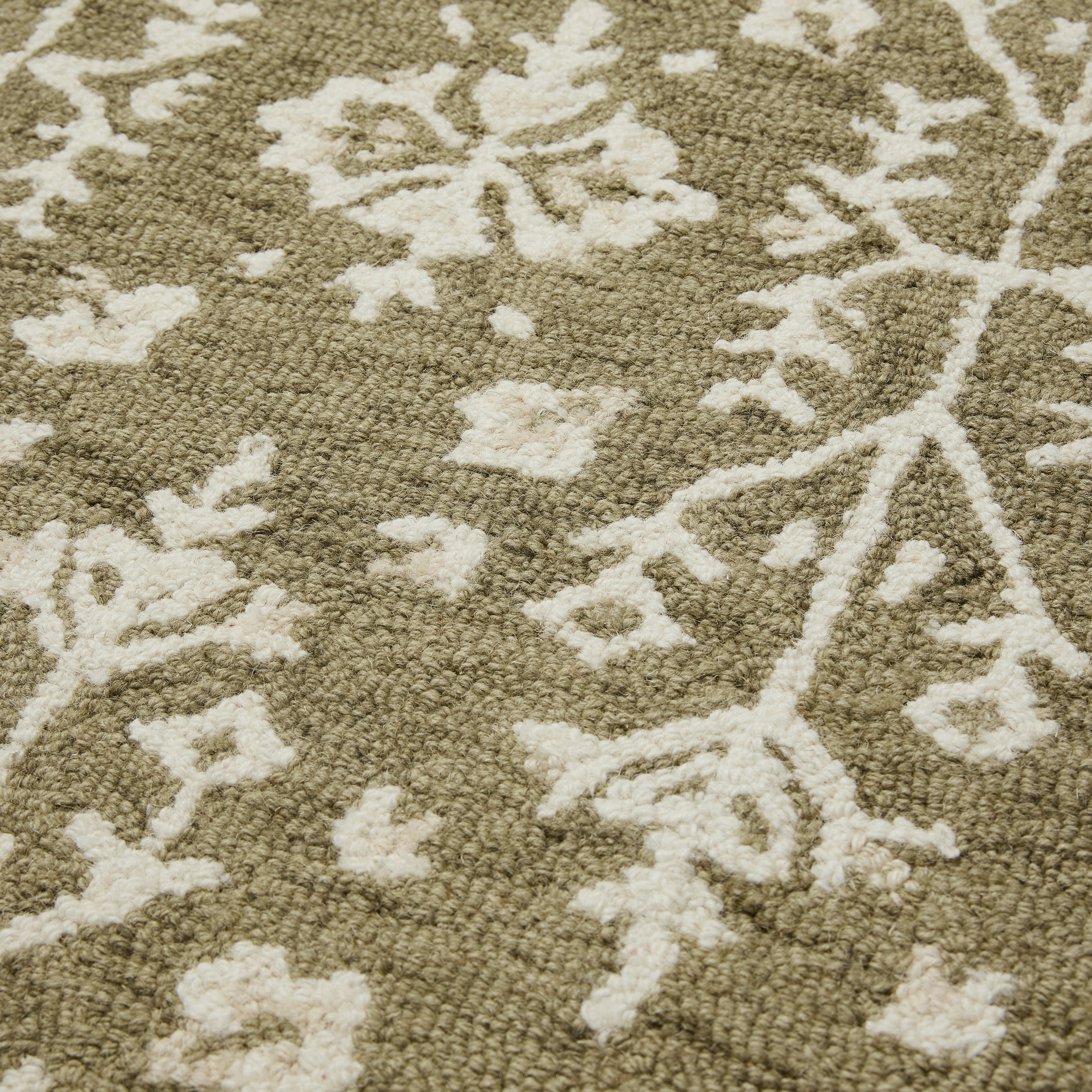 Olive green rug with traditional pattern gaudion furniture