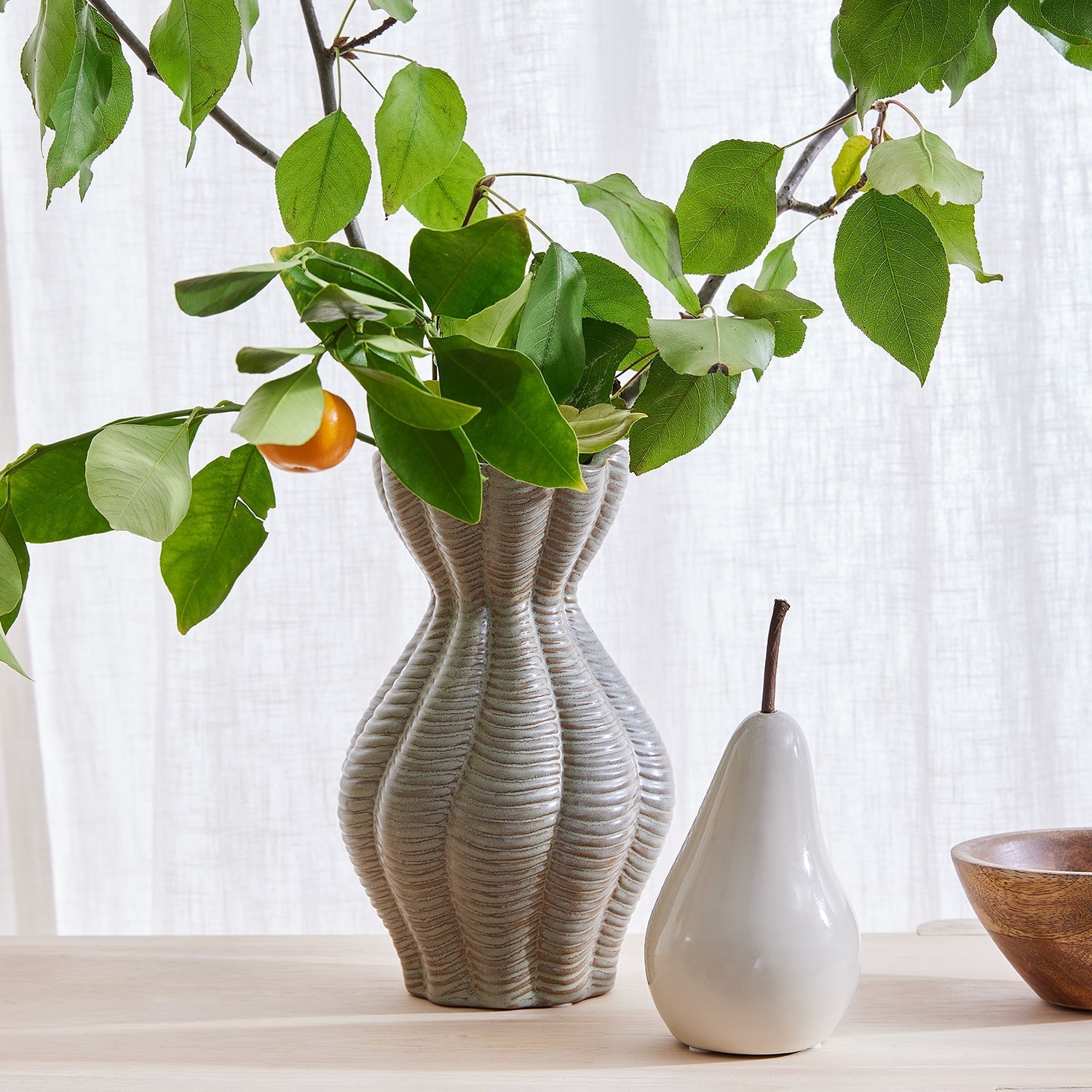 Small pear decoration Gaudion Furniture next to vase