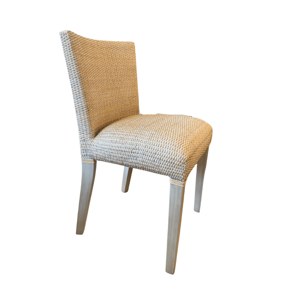 A single dining chair with a woven beige and white textured seat and backrest, supported by four light gray wooden legs,