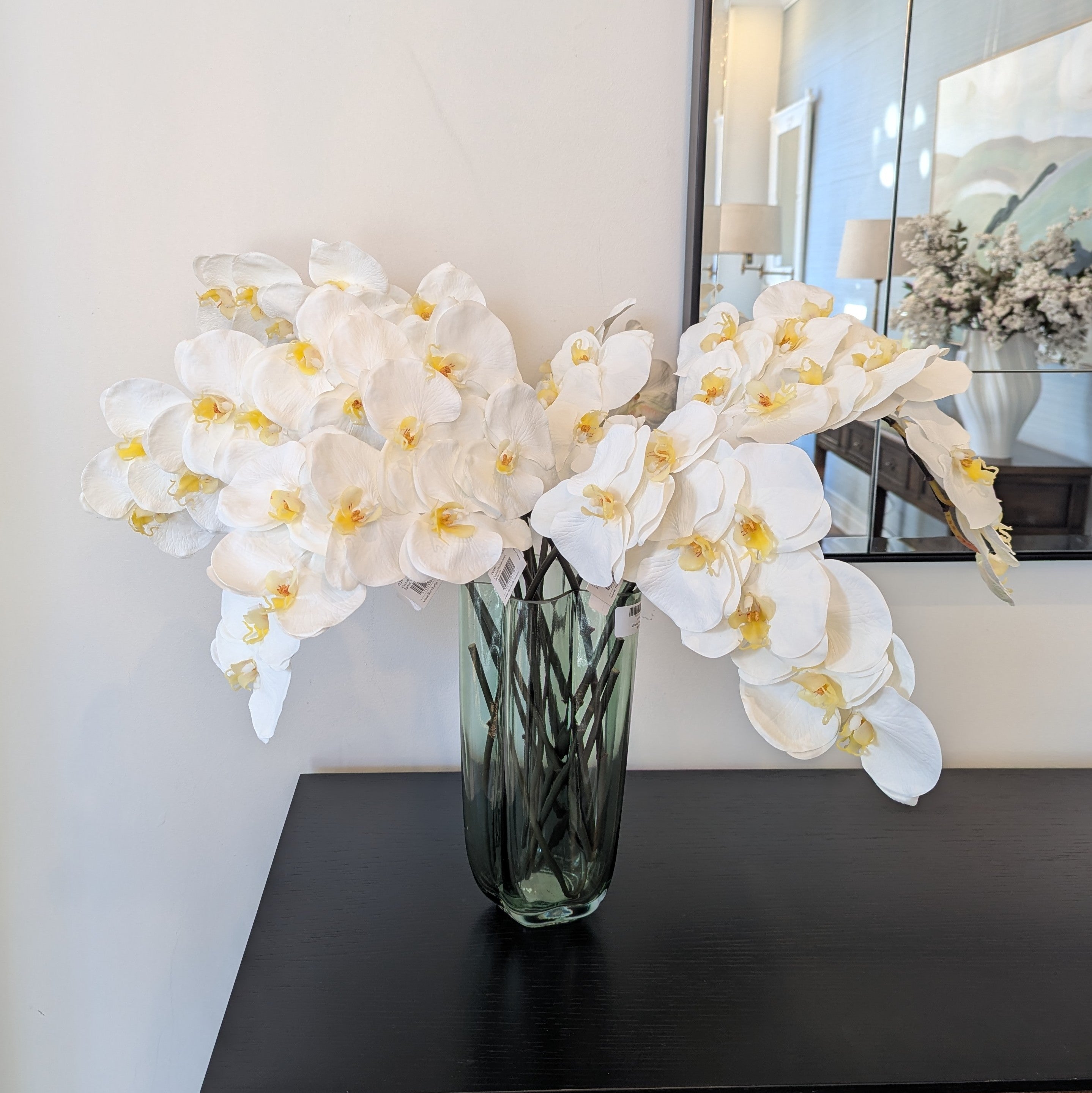 Bunch of orchid stems in white in vase gaudion furniture